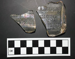 Two embossed broken glass artifacts.