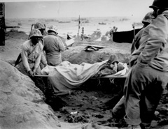 Marines carrying wounded on stretchers