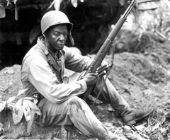 First Sergeant Rance Richardson sits holding gun
