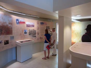 Visitors view the Battle of Coleto Creek exhibit at Fannin Battleground.