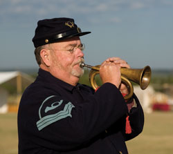 Soldier plays the bugle.