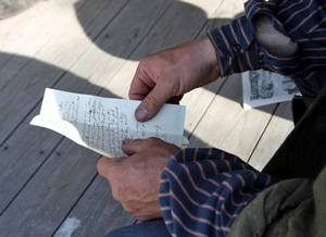 Man holds a letter in his hands.