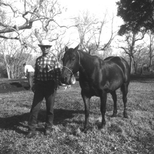 Hogg family ranch foreman Hal Fields with his beloved horse Buster, 1950s