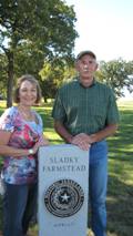 Couple standing next to a Historic Texas Lands Plaque