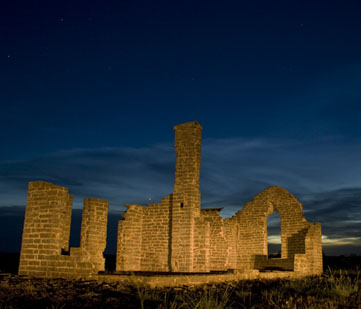 The fort ruins at night.