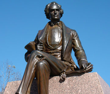 Photo of statue of Stephen F. Austin seated, photo taken from a lower angle gazing up at the statue