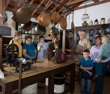 A tour group visits the kitchen.