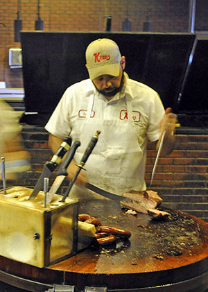 Picture of a man cutting brisket 