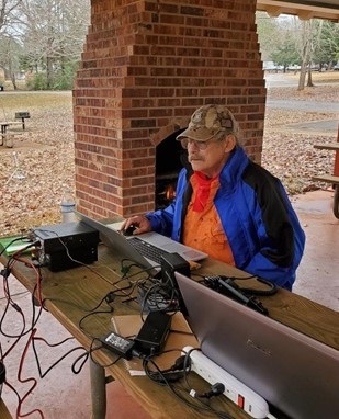 Picture of a man using a HAM radio 