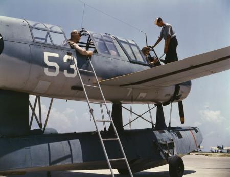 Aviation cadets in training at the Naval Air Base, Corpus Christi, Texas, in 1942, two crew work on plane in full color photograph