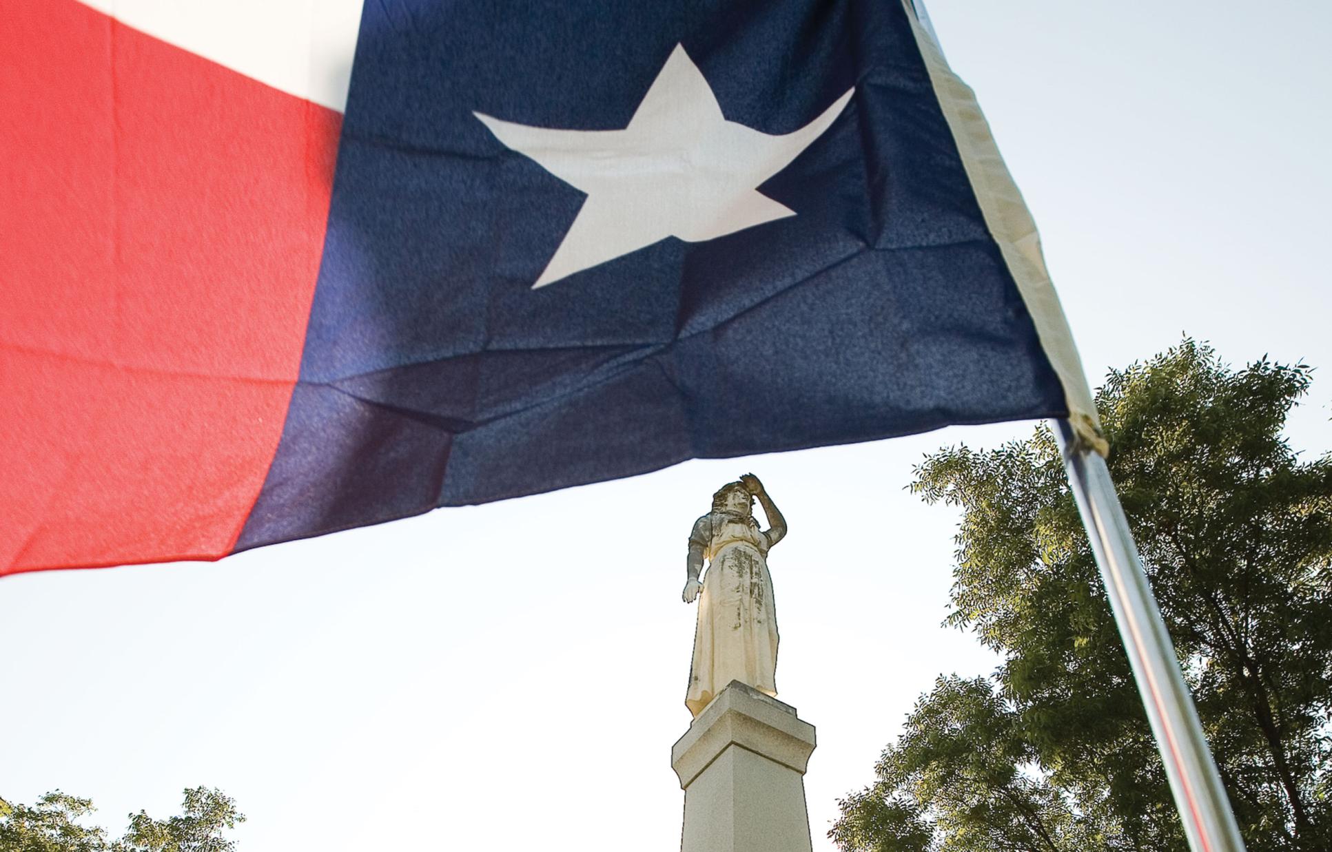Statue and Texas flag at Acton Cemetery