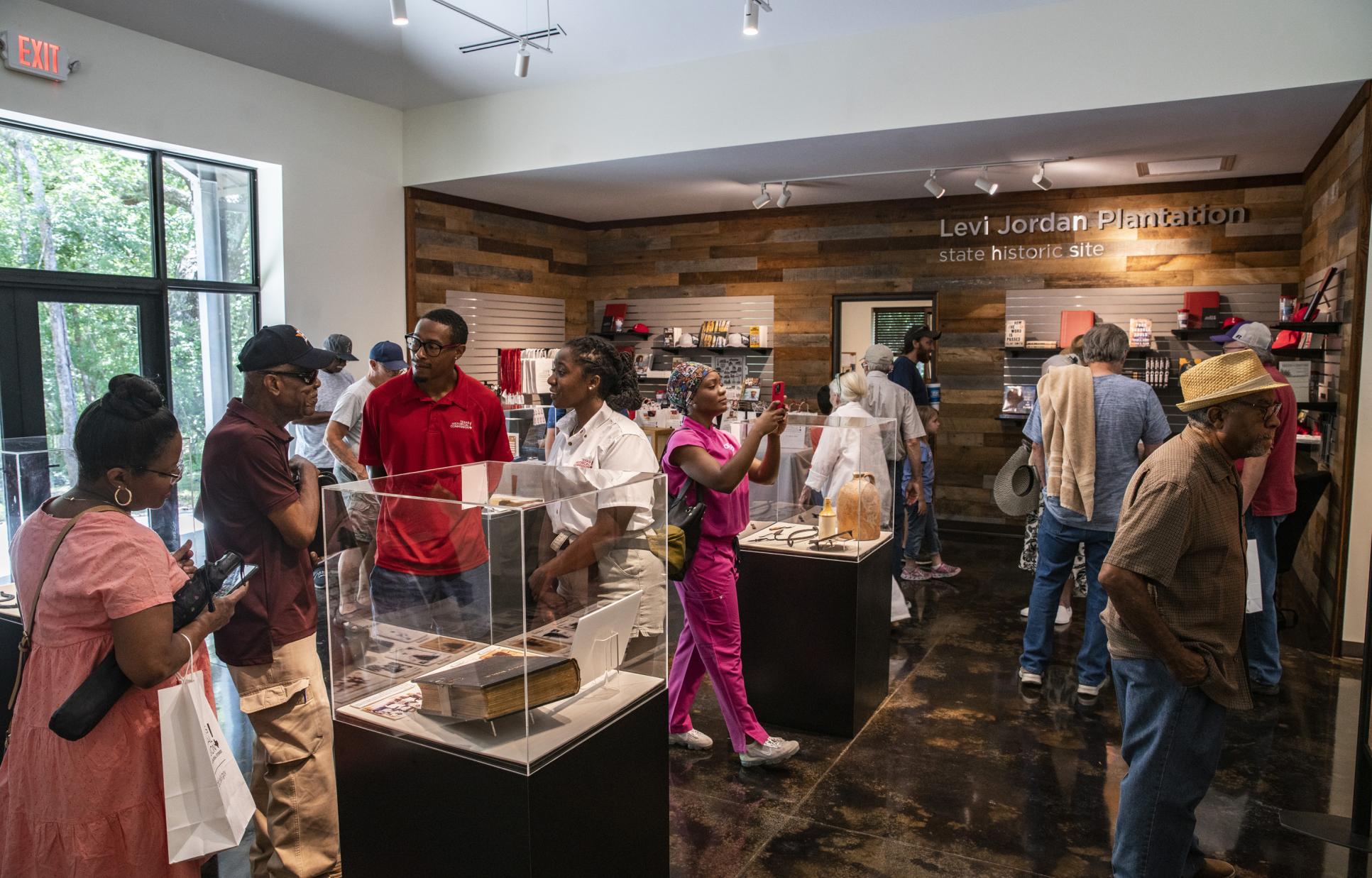Visitors in the exhibit gallery and gift shop at Levi Jordan