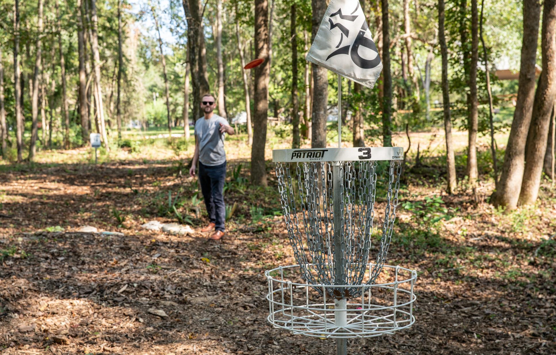 Visitor playing disc golf
