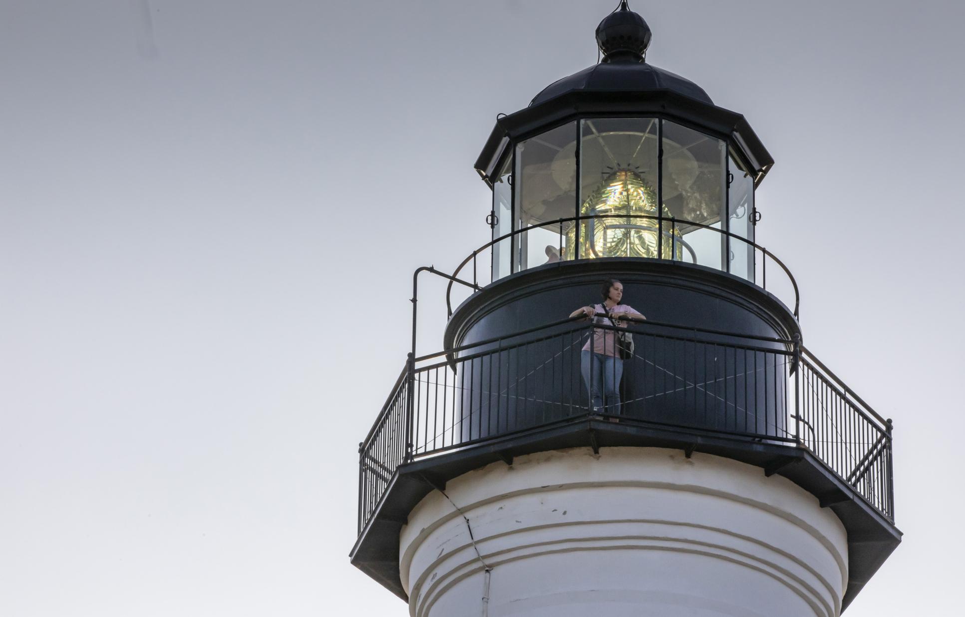 Visitor standing on balcony at the top of the Port Isabel Lighthouse