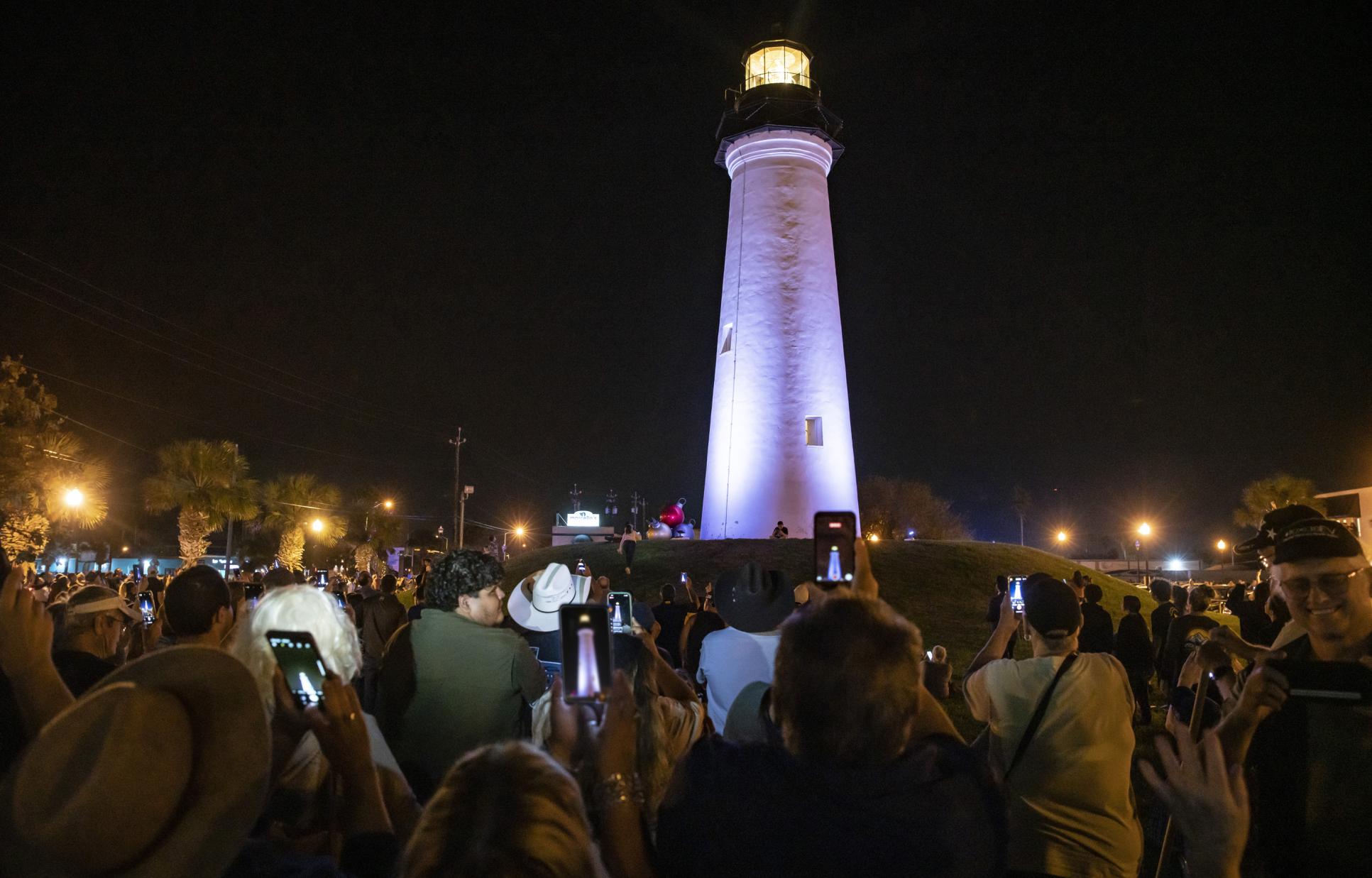 Crowd of visitors taking photos of the lighting of the Port Isabel Lighthouse