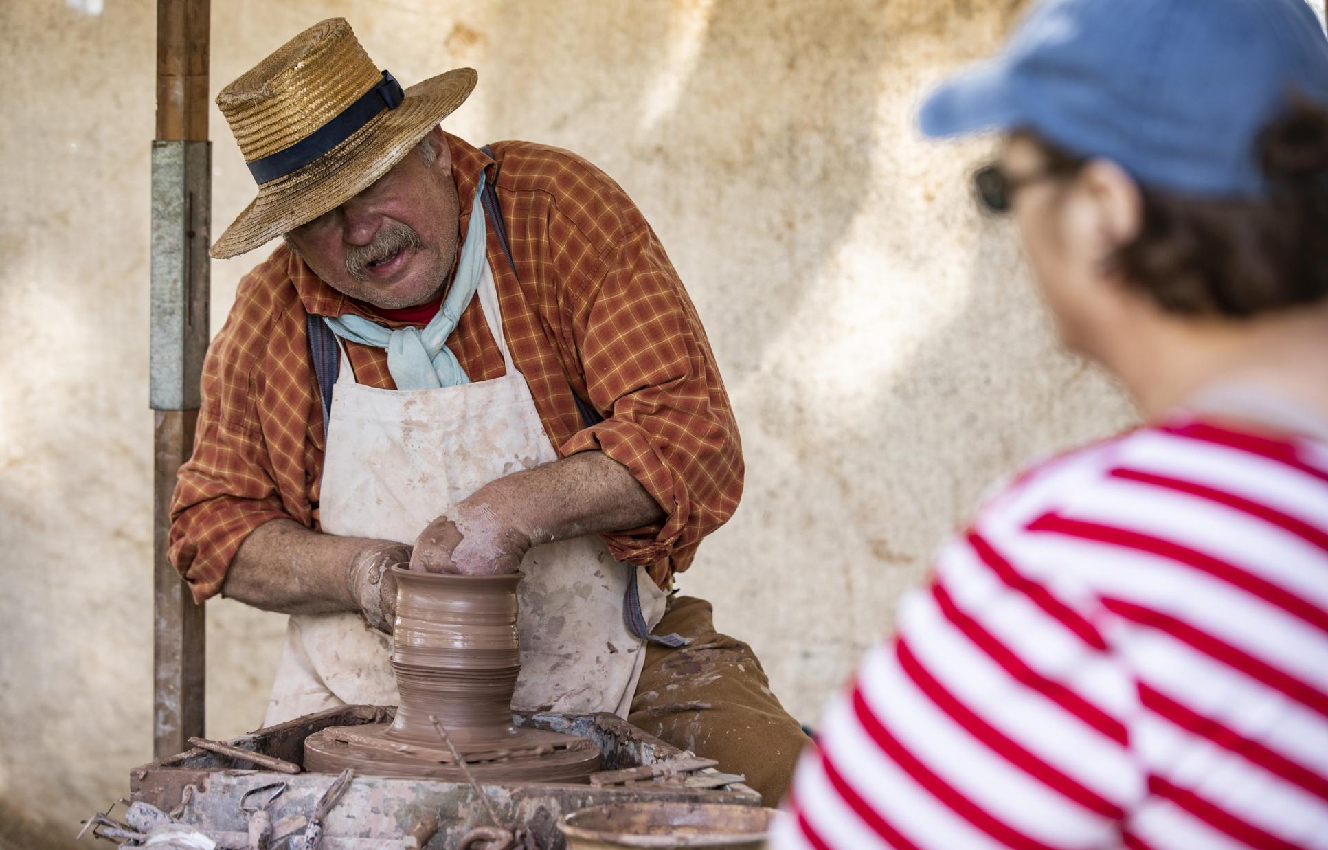 Reenactor demonstrating making pottery at Washington on the Brazos
